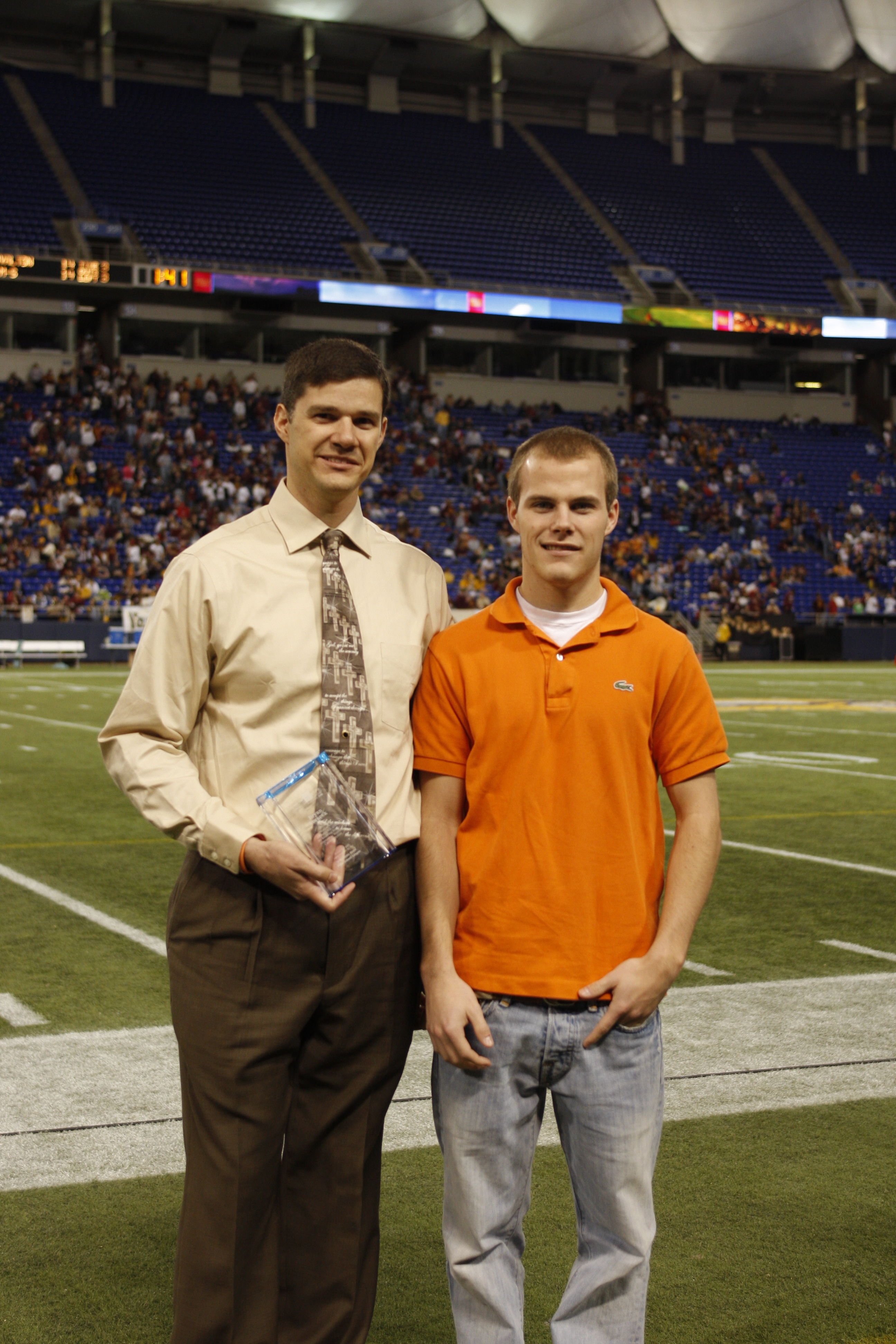 a hockey player standing next to his coach who saved his life